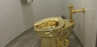 In this file photo taken on September 15, 2016, a fully functioning solid gold toilet, made by Italian artist Maurizio Cattelan, is going into public use at the Guggenheim Museum in New York