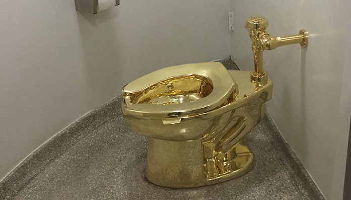 In this file photo taken on September 15, 2016, a fully functioning solid gold toilet, made by Italian artist Maurizio Cattelan, is going into public use at the Guggenheim Museum in New York